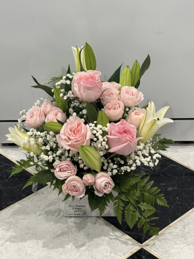 Blushing Elegance Bouquet - A graceful and romantic arrangement including pink roses, white lilies and baby's breath, all nestled among lush greenery.