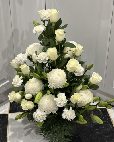 White Simplicity - Stunning pot arrangement of all white flowers with lush foliage. Perfect for conveying your sympathy & condolences.